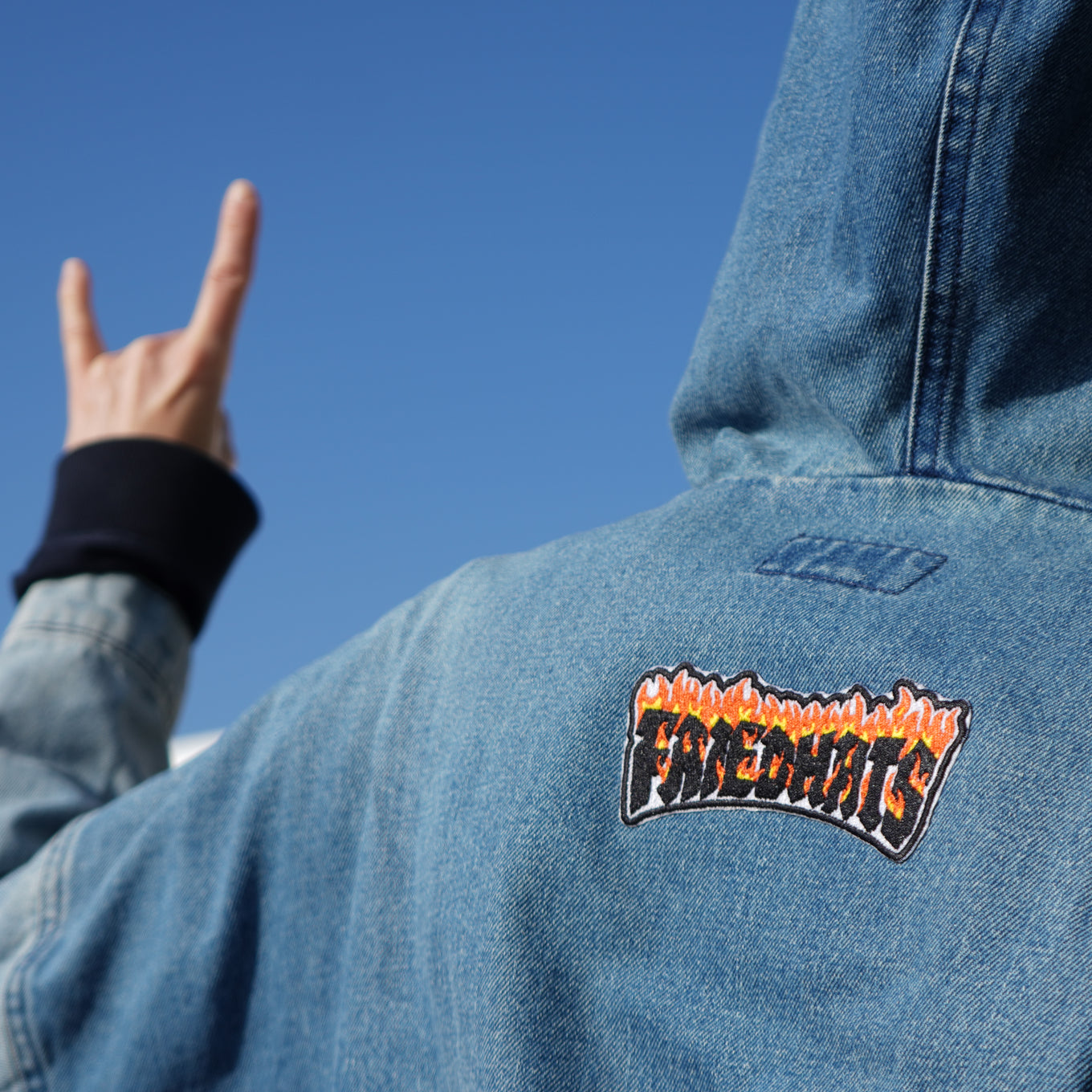 person wearing denim hoody with friedhats patch in the center